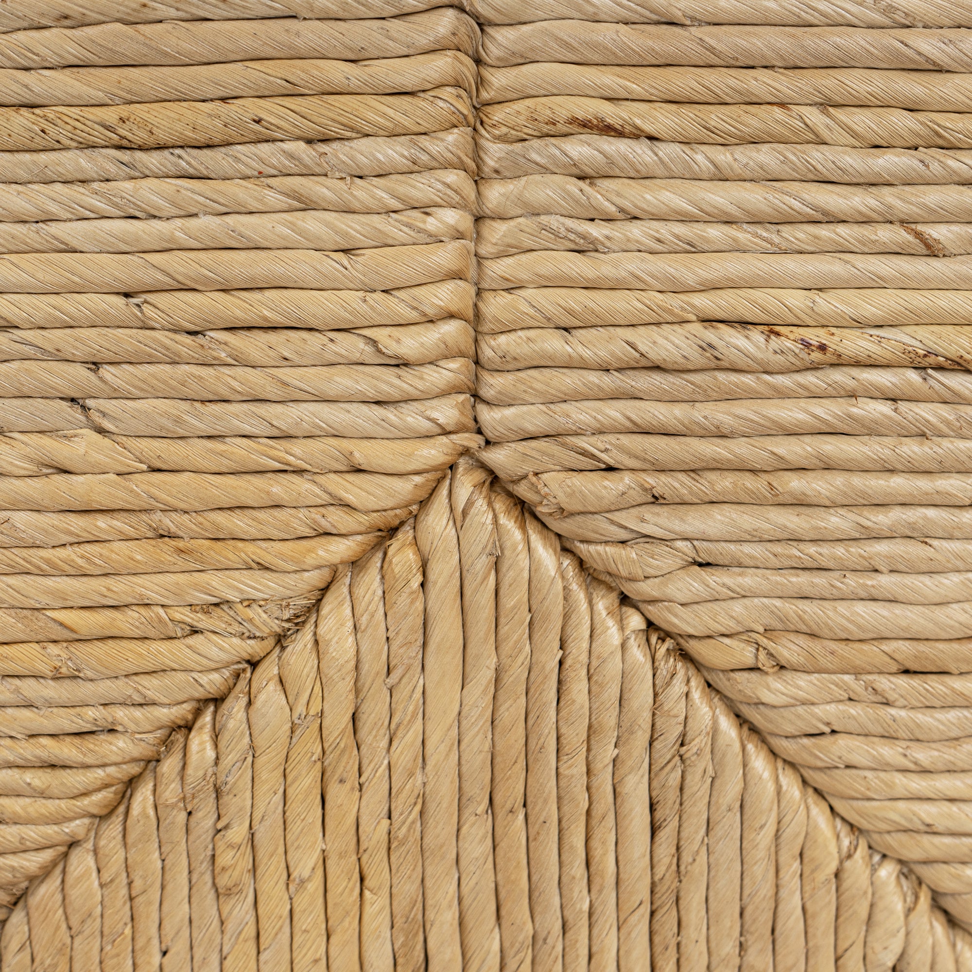 Close-up of woven straw mat with natural brown color