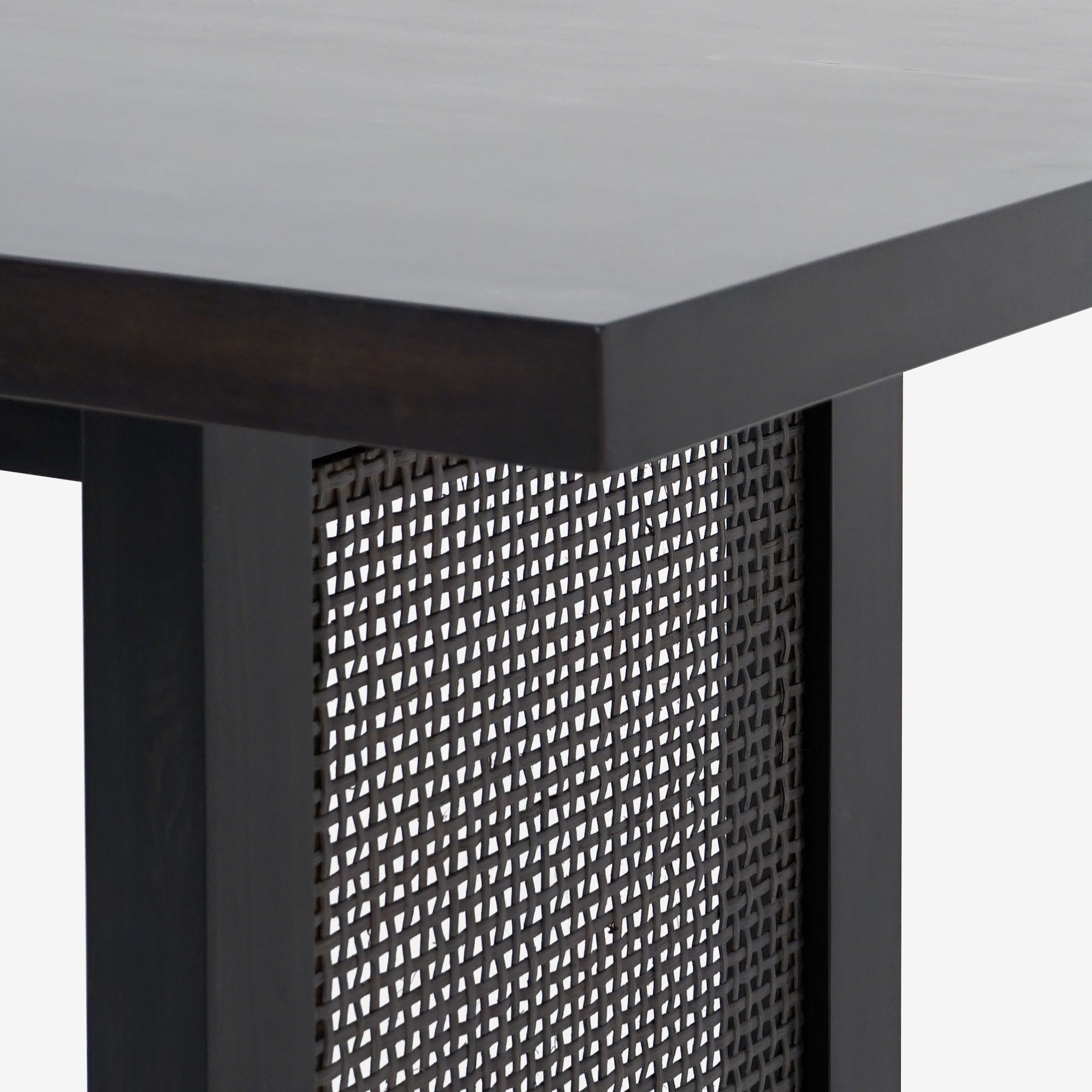 Close-up leg of Black Liora 72 x 30 Rattan Dining Table