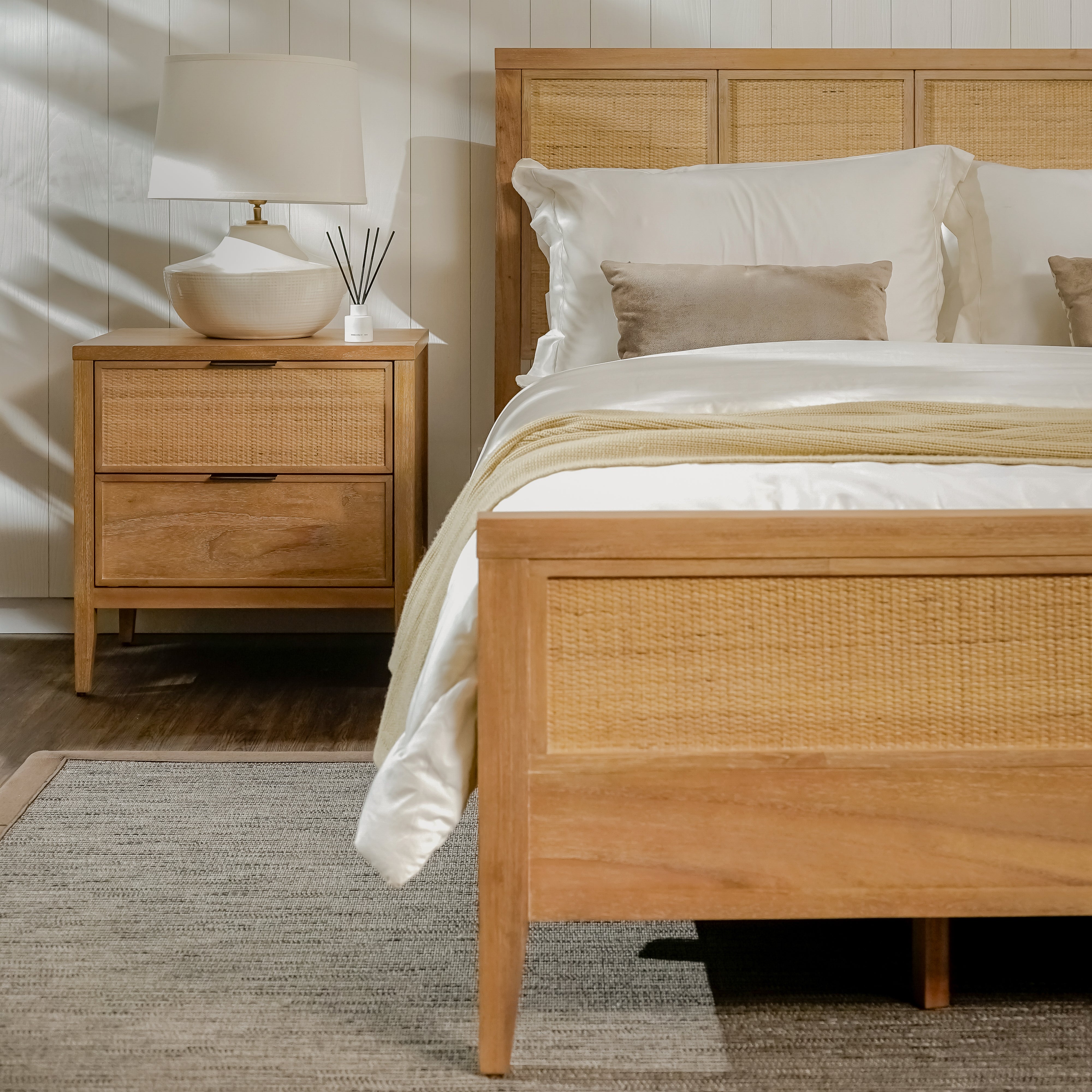 Wooden bed with matching nightstand in a bedroom setting