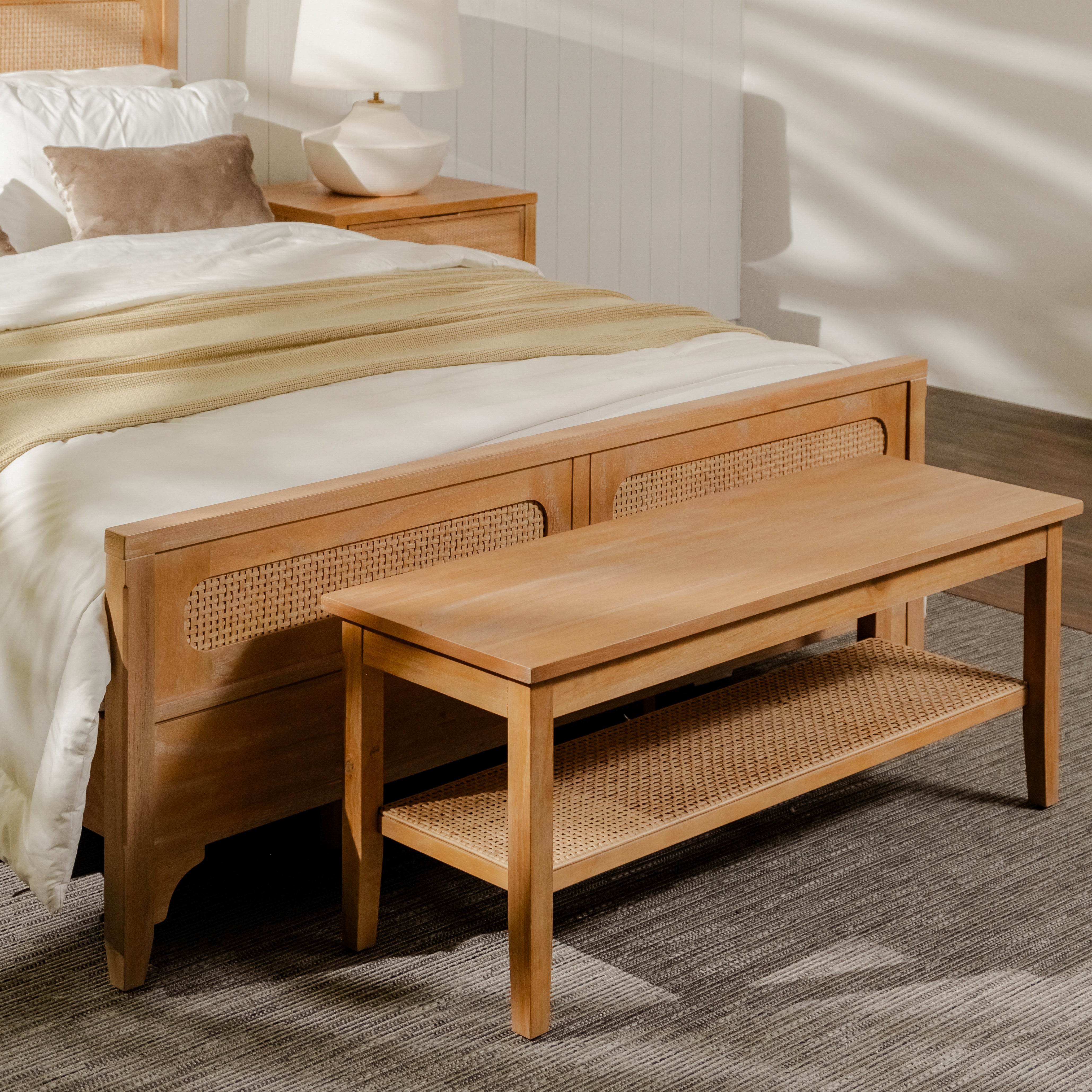 Wooden bed with wicker bench in a bedroom setting