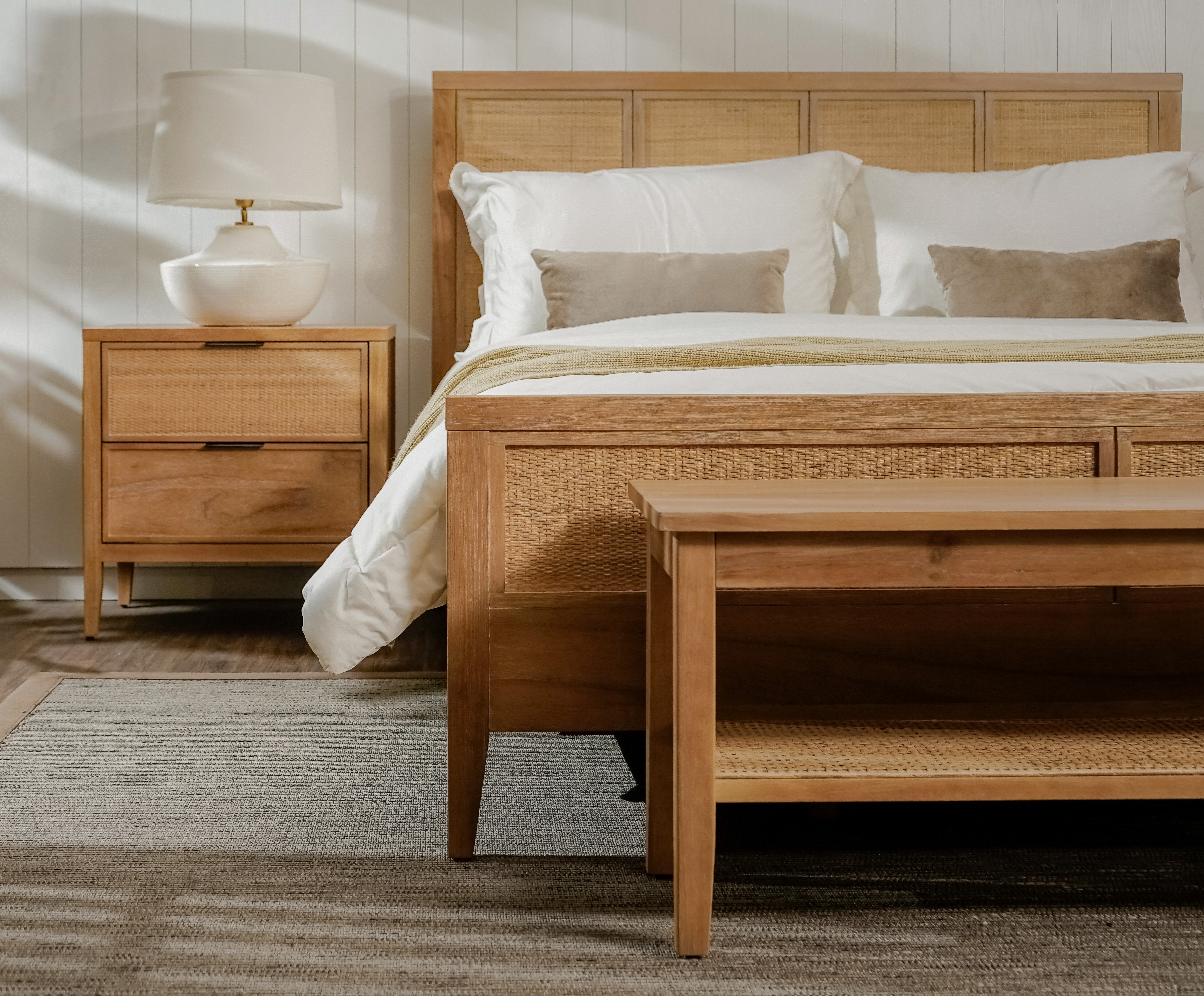 Wooden bed with white bedding in a bedroom setting