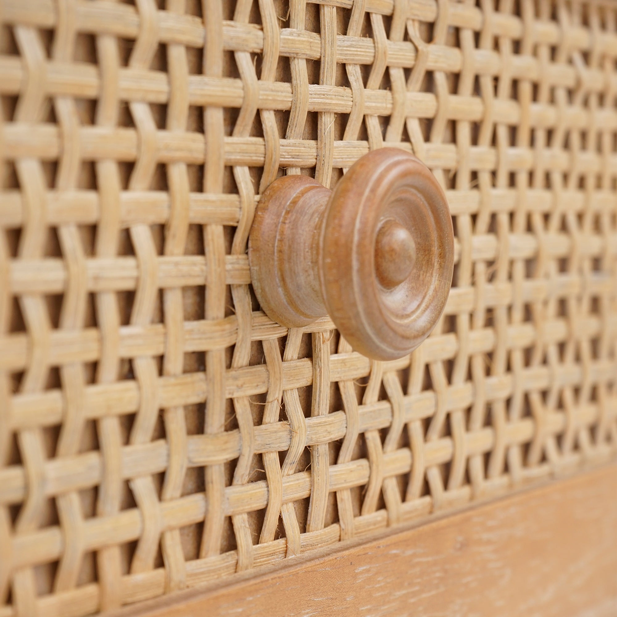 Close-up of a wooden woven basket with a round wooden handle.