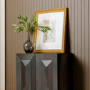 Decorative setup with a gold-framed mirror, vase with greenery, and Black Averi Modular Cabinet against a striped wall.