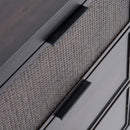 Close-up of a textured cabinet with black handles