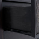 Close-up of a chair with woven backrest and dark wooden frame.