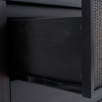 Close-up of a chair with woven backrest and dark wooden frame.