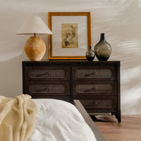 Wooden dresser with decorative items in a bedroom setting