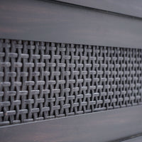 Close-up of a textured metal surface with a grid pattern