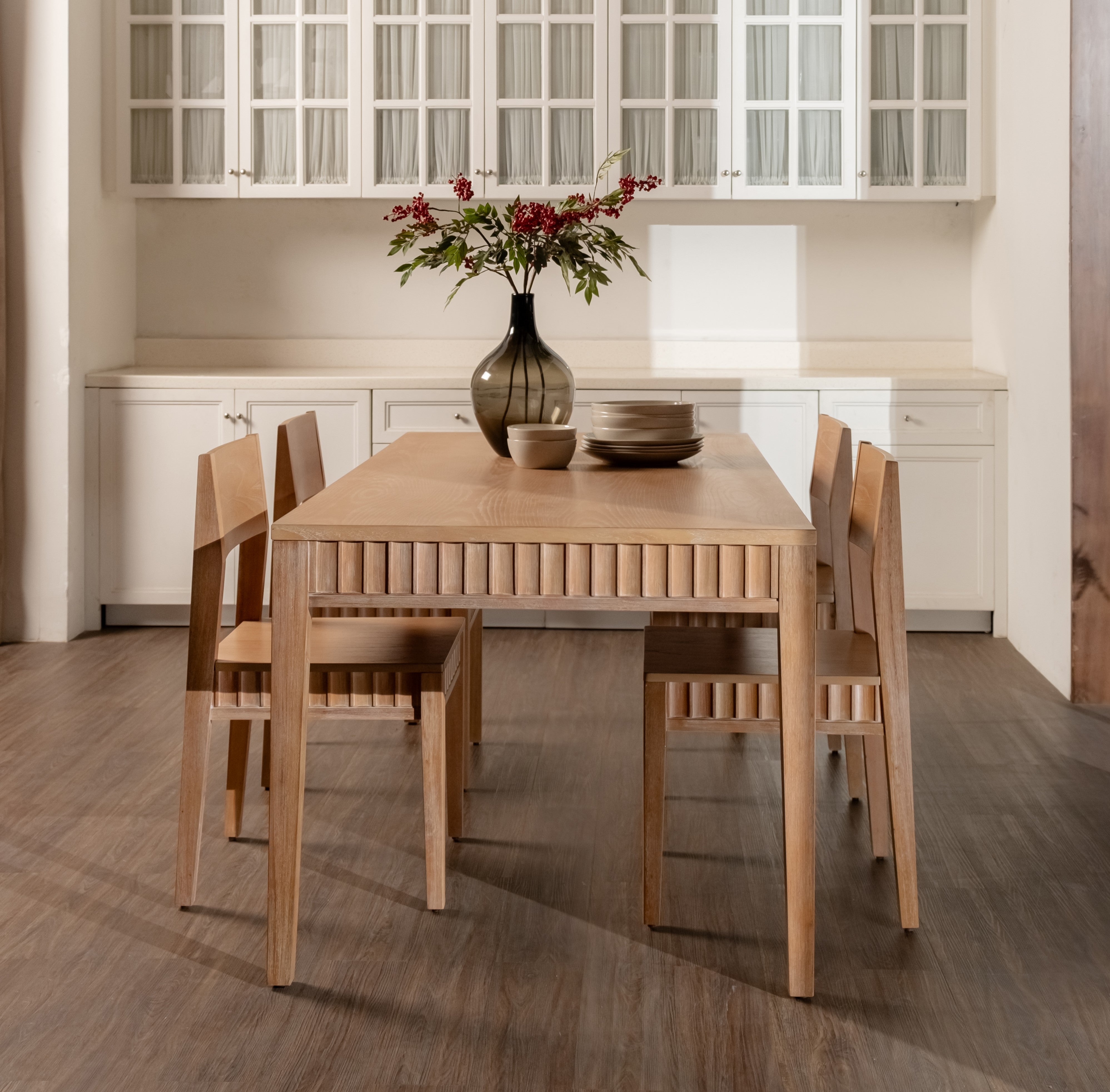 Dining area with wooden table and chairs in a kitchen setting