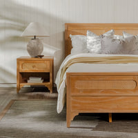 Wooden bed with wicker accents in a bedroom setting